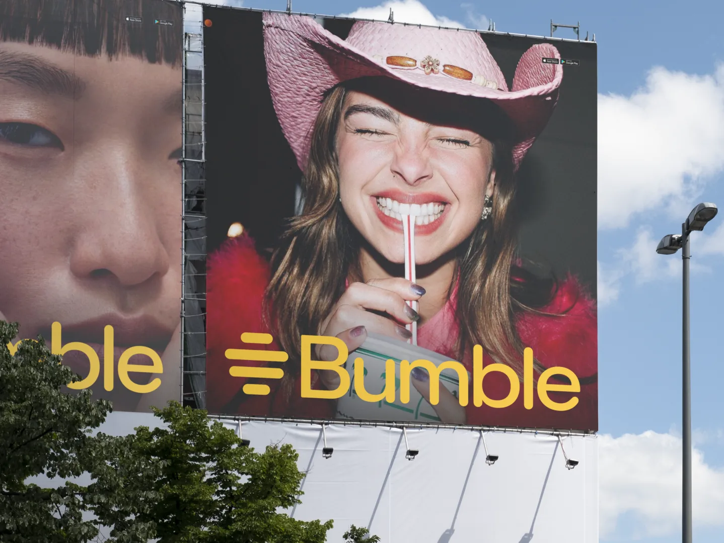 Bumble billboard featuring a smiling woman in a pink cowboy hat